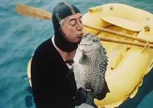 Harold Holt in diving gear with fish taken from a home moy.